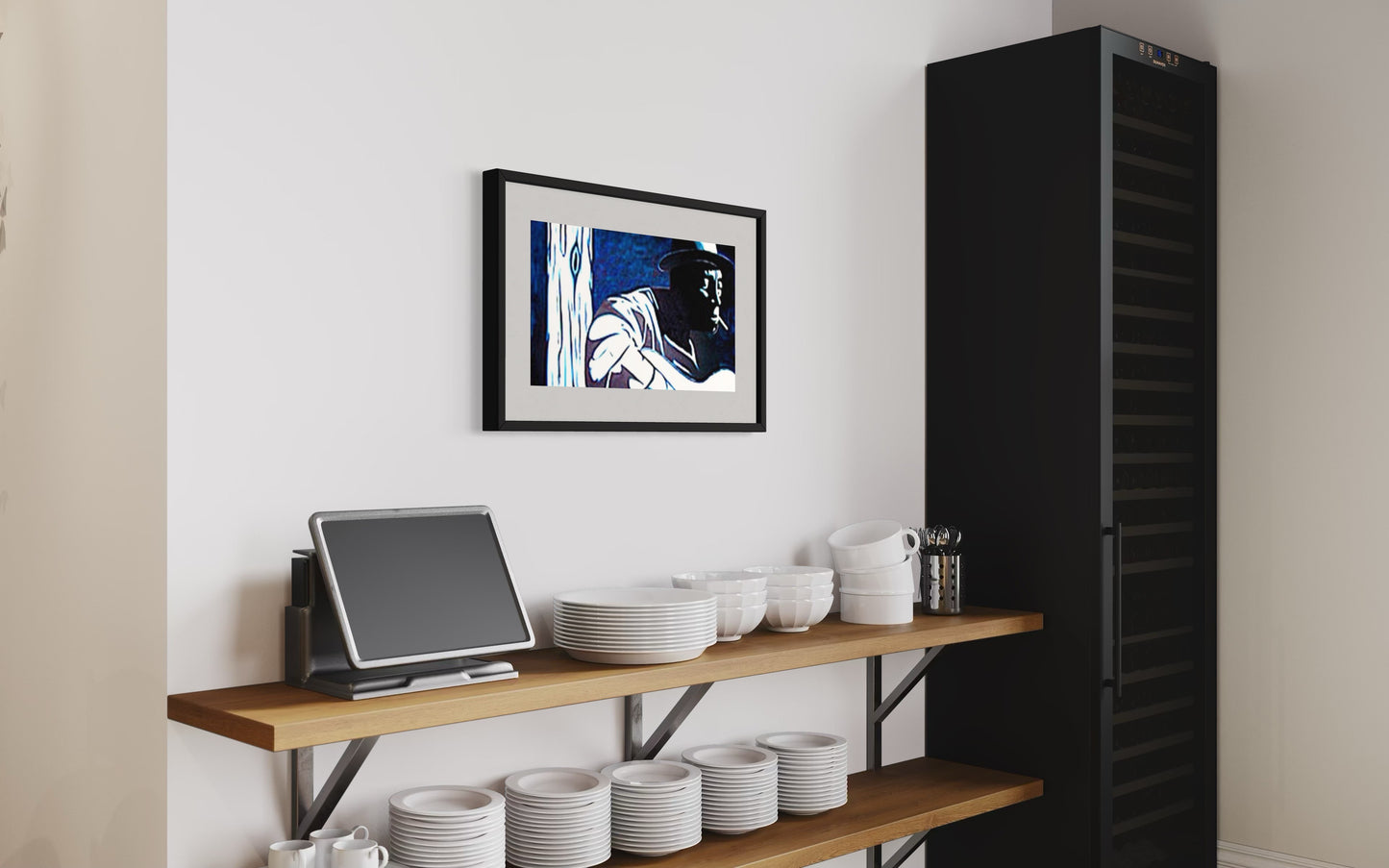 Kitchen setup with a black refrigerator, wooden shelf with kitchenware, and framed picture on the wall.  A stylish interior scene featuring a framed blues player-inspired art print of a musician in dark smokey room, Mississippi John Hurt.   Monochromatic style hanging above modern restaurant shelves with a kiosk and white plates, coffee cups, and saucers giving the space a warm, creative, and music-inspired atmosphere.