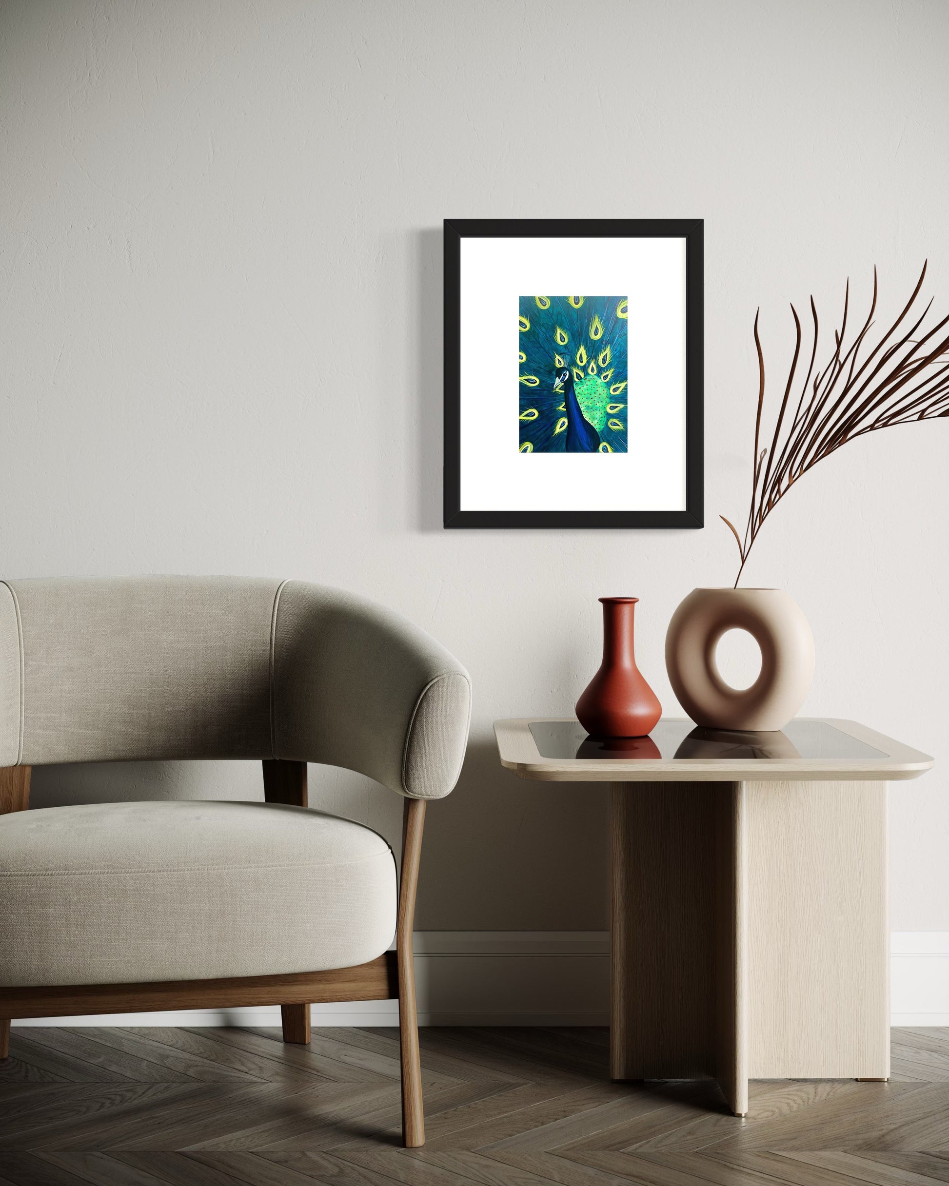 A refined interior featuring a framed peacock art print with vibrant blue and green feathers displayed on a white wall. Below, a modern off white side table and modern upholstered off white  sati. A  red modern vase and white round vase with a peacock feather are on the side table.  Creating a calm, elegant, and inviting atmosphere.  Great for any modern space. 