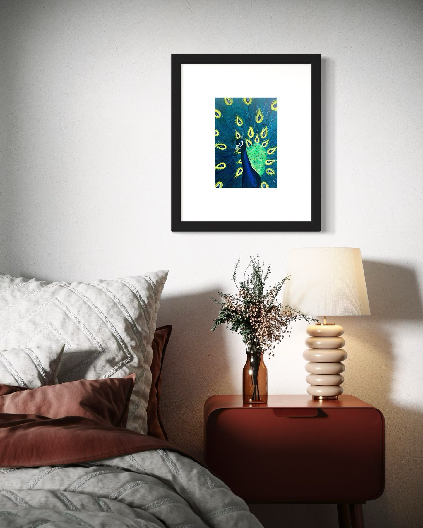 A refined interior featuring a framed peacock art print with vibrant blue and green feathers displayed on a white wall above a modern bed and side table with a vase, flowers and modern lamp. Creating a calm, elegant, and inviting atmosphere.  Great for any modern space. 