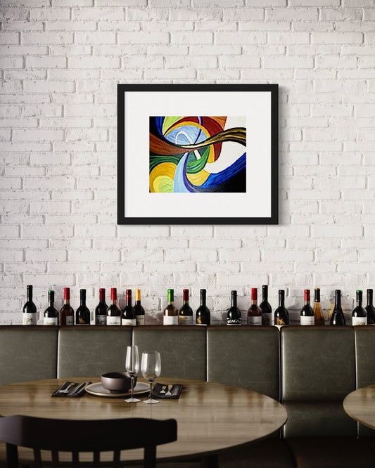 A contemporary dining space with a framed abstract art print featuring colorful flowing swirl shapes in multi color blue, yellow, red, and brown tones on a white brick wall. Below, a row of wine bottles lines a shelf behind a leather banquette. A wooden table is set with plates and wine glasses, creating a warm, modern atmosphere with an artistic focal point.  Great for restaurants, bars, or home decor.  