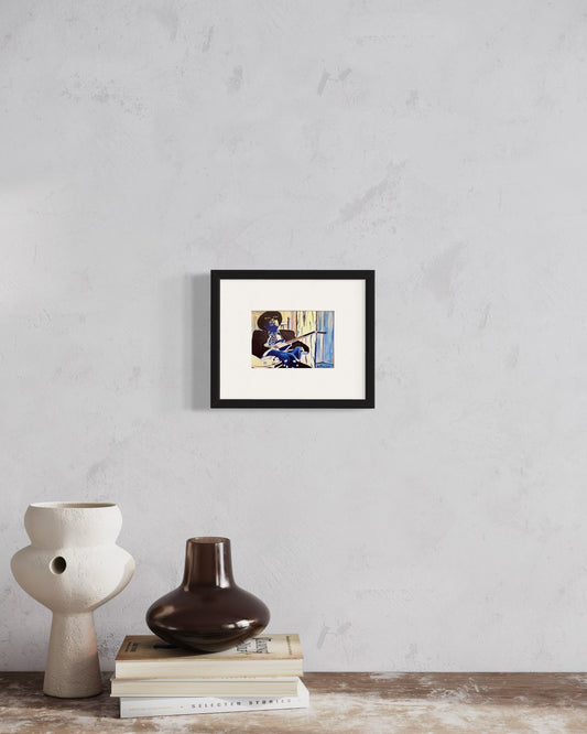 Framed artwork on a wall with decorative vases and books below.  A contemporary interior with a framed print of the blues guitarist, Johnny Lee Hooker, in monochromatic blue and white tones displayed on a white wall. The space feels modern, curated,  artistic, and inspired by music and creativity.