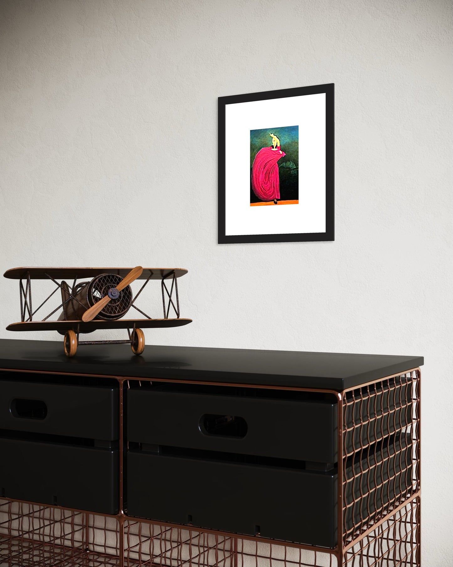 Framed archival print of a flamenco dancer about to perform in a deep pink dress, with a guitarist faintly seen in the background.  The print shown with a white mat and black frame.  In front is a modern set of drawers and a model antique vintage airplane.  Great for any modern den, office, music room, bedroom, or living room.  